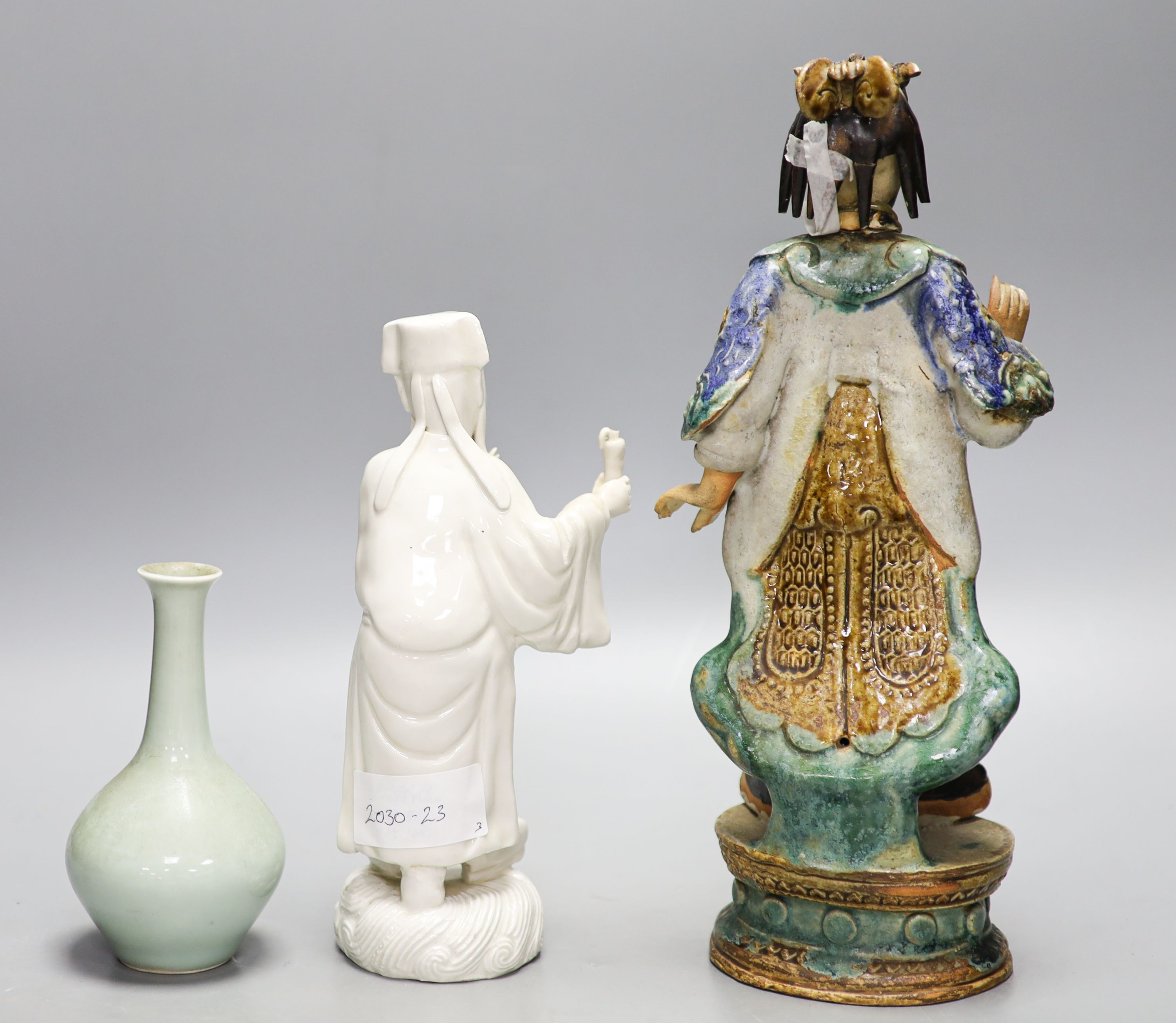 A Chinese blanc de chine figure, and Shiwan pottery figure and a celadon glazed bottle vase